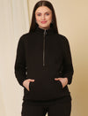 Pregnant woman wearing black fleece maternity co-ord set with front zip sweatshirt and kangaroo pocket