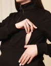 Close-up view of nursing zipper on black winter maternity sweatshirt, showing easy breastfeeding access