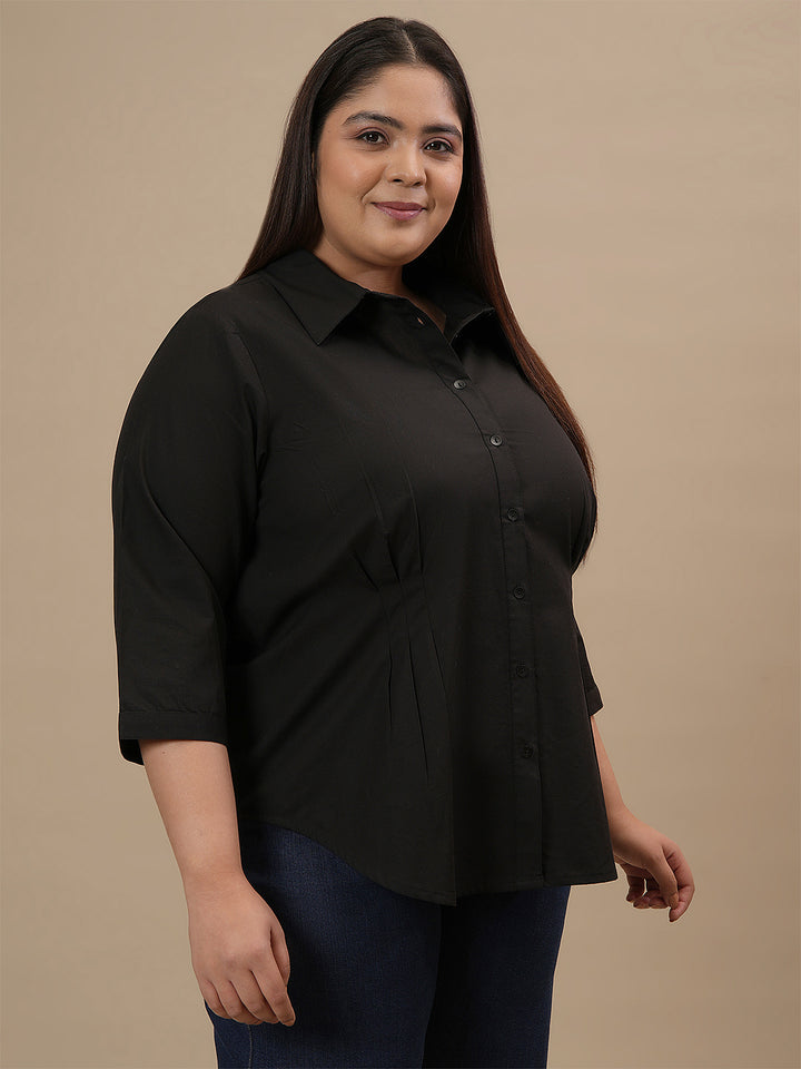 Plus-size woman in front right angle view wearing Black Cotton Plus Size Formal Top with clean lines and formal style