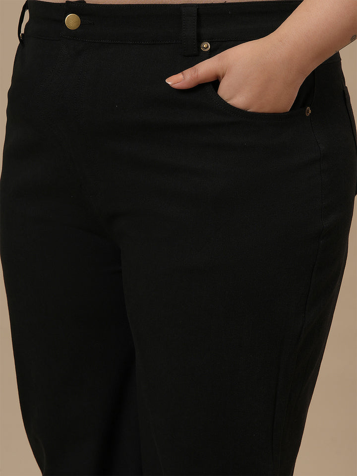 Close-up view of Black Plus Size Bootcut Jeans showing high-rise waistband and stretch denim texture