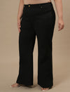 Plus-size woman in left side view wearing Black Plus Size Bootcut Jeans featuring slim fit through thigh and bootcut leg