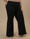Plus-size woman in right side view wearing Black Plus Size Bootcut Jeans with high waist and flared hem