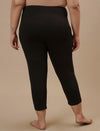 Plus-size woman in back view wearing Black Plus Size Capri Pants with clean back and tapered hem