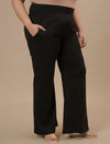 Plus-size woman styled in Black Plus Size Flare Pants with flattering flare and fitted waist