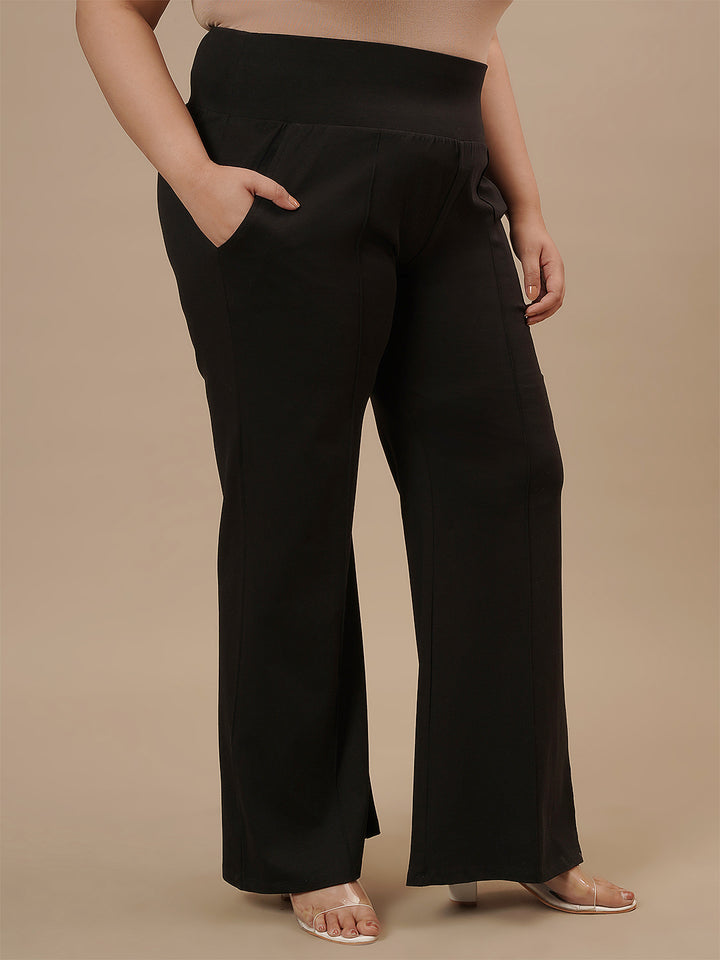 Plus-size woman styled in Black Plus Size Flare Pants with flattering flare and fitted waist