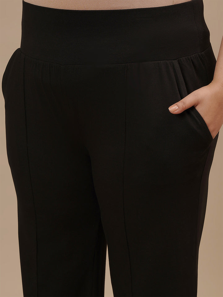 Close-up view of Black Plus Size Flare Pants showing waistband detail and smooth stretch fabric