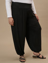 Plus-size woman in right side view wearing Black Plus Size Harem Pants featuring dropped crotch and airy fit