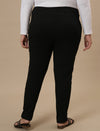 Plus-size woman in back side view wearing Black Plus Size Jeggings with high-rise waist and contoured fit