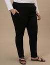 Plus-size woman in front right angle view wearing Black Plus Size Jeggings with high-rise waist and slim fit silhouette