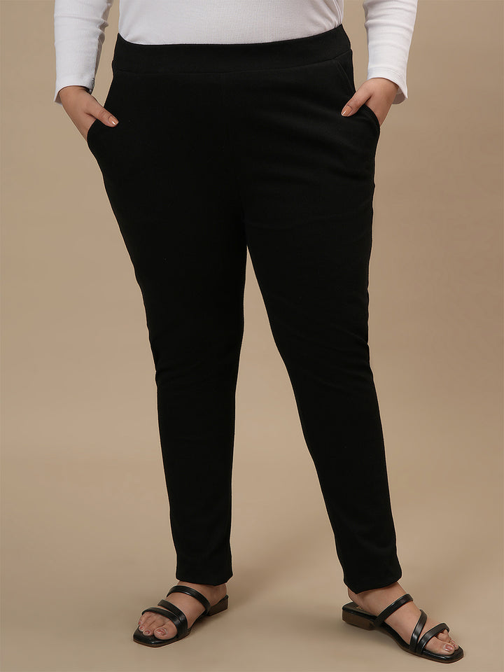 Plus-size woman in front view wearing Black Plus Size Jeggings with high-rise waist and body-hugging fit