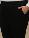 Close-up view of Black Plus Size Jeggings showing high-rise waistband and stretch denim fabric