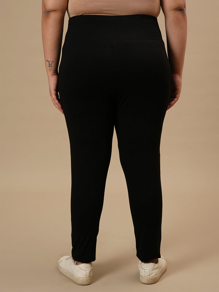 Plus-size woman in back view wearing Black Plus Size Leggings With Pockets featuring high-rise waist and back seam detail