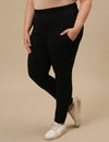 Plus-size woman in front left angle view wearing Black Plus Size Leggings With Pockets featuring high-rise waist and side pockets