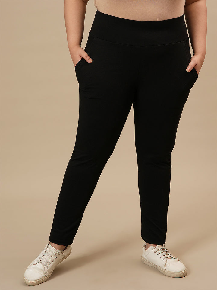 Plus-size woman in front view wearing Black Plus Size Leggings With Pockets featuring high-rise waist and functional pockets