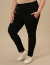 Plus-size woman in left side view wearing Black Plus Size Leggings With Pockets featuring high-rise waist and side pockets