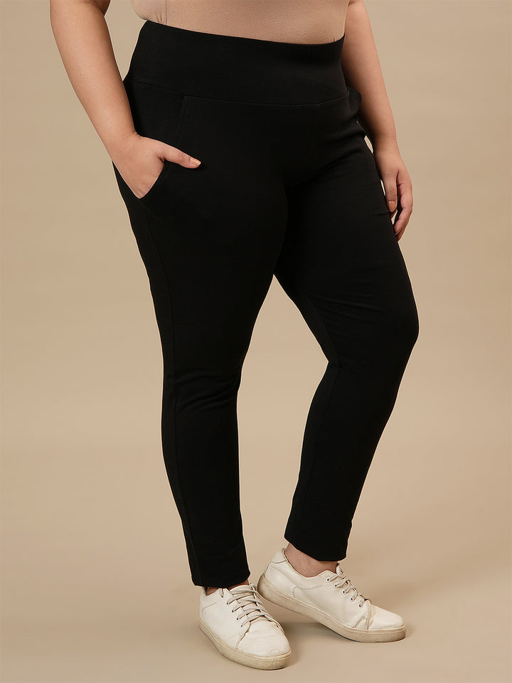 Plus-size woman in right side view wearing Black Plus Size Leggings With Pockets featuring high-rise waist and side pockets