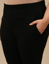 Close-up view of Black Plus Size Leggings With Pockets showing high-rise waistband and stretch fabric