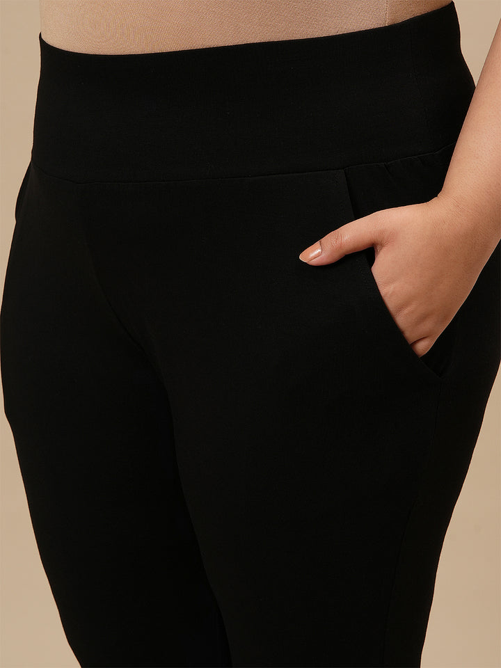 Close-up view of Black Plus Size Leggings With Pockets showing high-rise waistband and stretch fabric