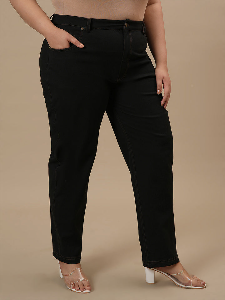 Plus-size woman in side view wearing Black Plus Size Straight Fit Jeans with mid-rise waist and straight leg design