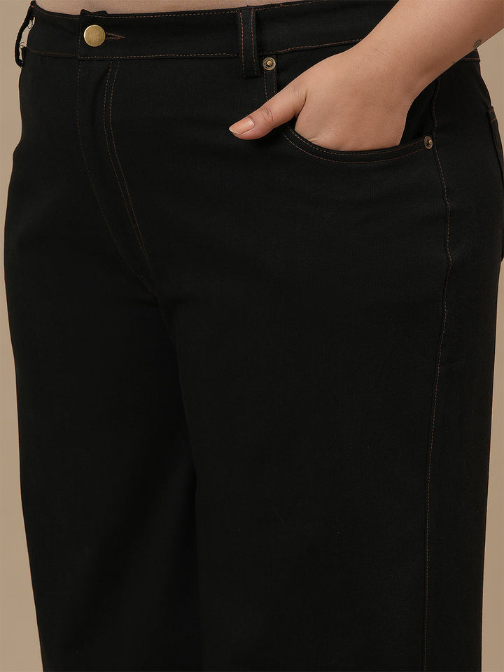 Close-up view of Black Plus Size Wide Leg Jeans showing waistband and smooth denim texture