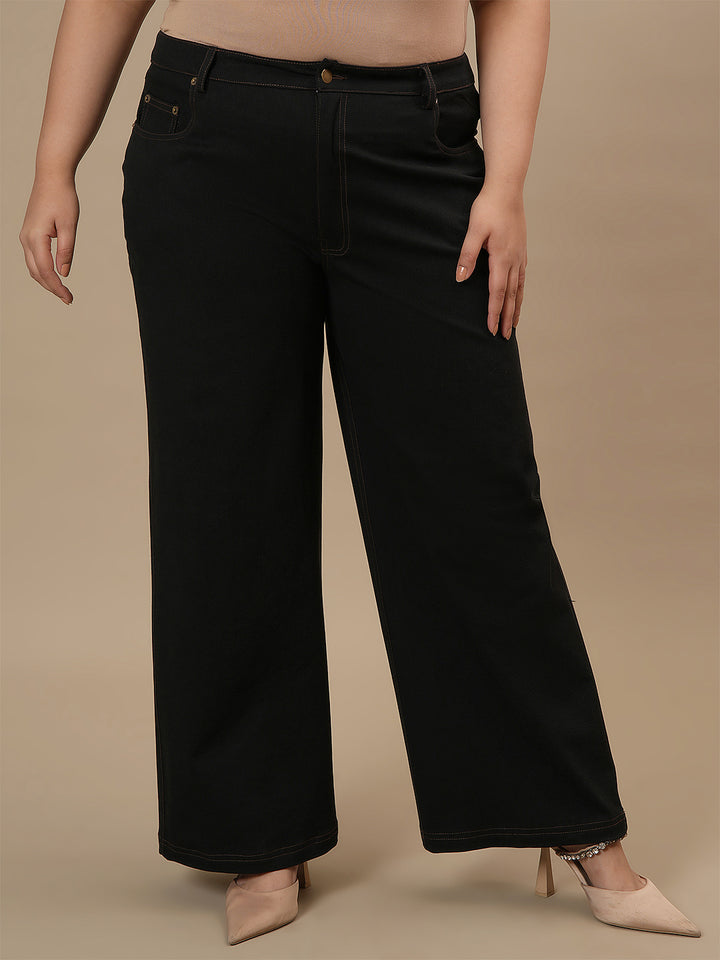 Plus-size woman in angled front view wearing Black Plus Size Wide Leg Jeans featuring relaxed leg and clean front