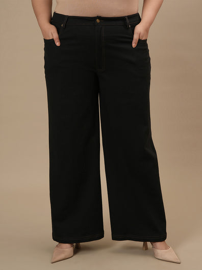 Plus-size woman in style shoot wearing Black Plus Size Wide Leg Jeans with structured fit and soft fabric