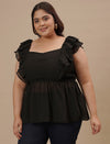 Plus-size woman in angled front view wearing Black Sleeveless Plus Size Peplum Top with a flared waist and sleeveless design