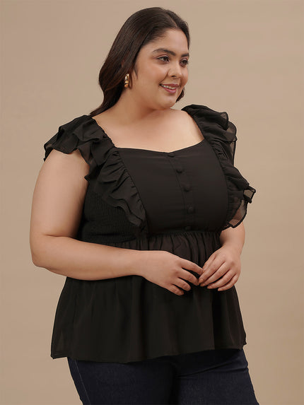 Plus-size woman in right side view wearing Black Sleeveless Plus Size Peplum Top with defined waist and flared bottom