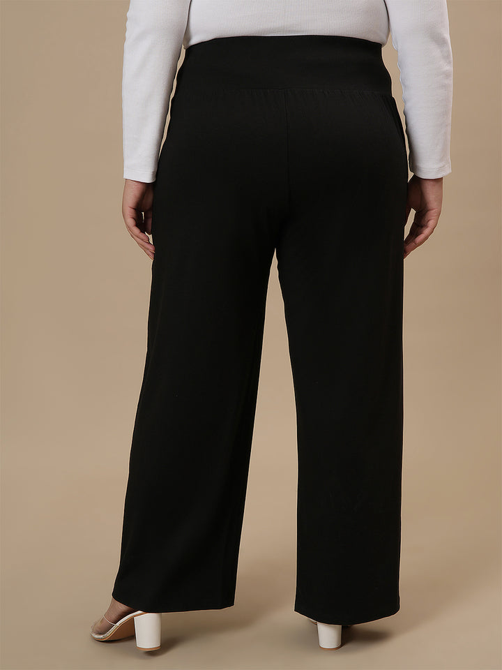 Plus-size woman in back view wearing Black Wide Leg Plus Size Pants with smooth back and wide-leg cut