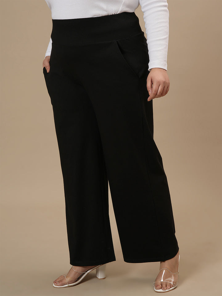 Plus-size woman in left side view wearing Black Wide Leg Plus Size Pants featuring relaxed fit and wide-leg style