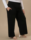 Plus-size woman in right side view wearing Black Wide Leg Plus Size Pants with flowy fit and high waist