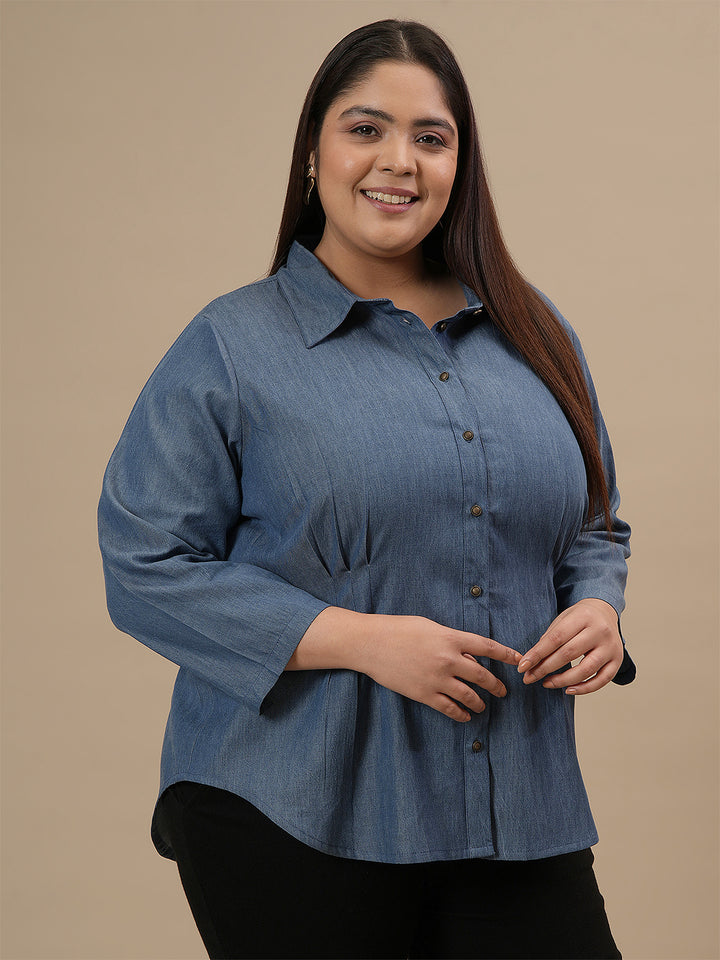 Plus-size woman in front right angle view wearing Plus Size Blue Denim Shirt with full sleeves and button-down front