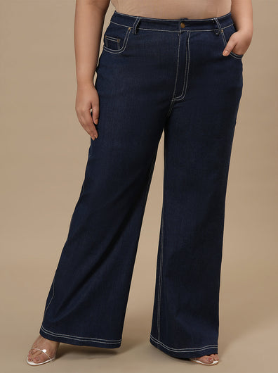 Plus-size woman in front view wearing Blue Plus Size Bootcut Jeans featuring high-rise waist and flared leg