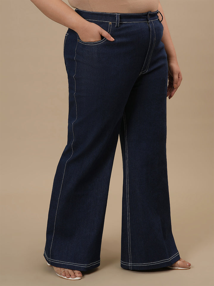 Plus-size woman in right side view wearing Blue Plus Size Bootcut Jeans with high waist and flared hem