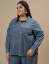 Plus-size woman in left side view wearing Blue Plus Size Denim Shirt featuring full sleeves and classic denim styling