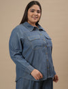 Plus-size woman in right side view wearing Blue Plus Size Denim Shirt with button-down front and relaxed fit