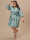 Plus-size woman in front pose wearing Blue Plus Size Satin Dress with V-neckline and elegant satin sheen