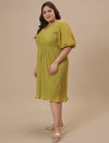 Plus-size woman in front left angle view wearing Green Pleated Plus Size Formal Dress with wrap bodice and flared hem