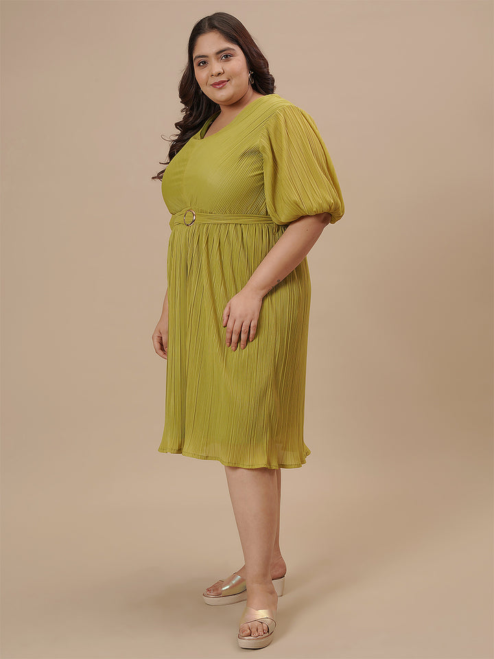 Plus-size woman in front left angle view wearing Green Pleated Plus Size Formal Dress with wrap bodice and flared hem