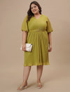 Plus-size woman in front view holding a bag while wearing Green Pleated Plus Size Formal Dress with pleated detail