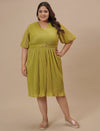 Plus-size woman in front view wearing Green Pleated Plus Size Formal Dress with V-neck and flowy pleated skirt