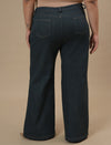 Plus-size woman in back view wearing Green Plus Size Bootcut Jeans with fitted hips and flared leg design