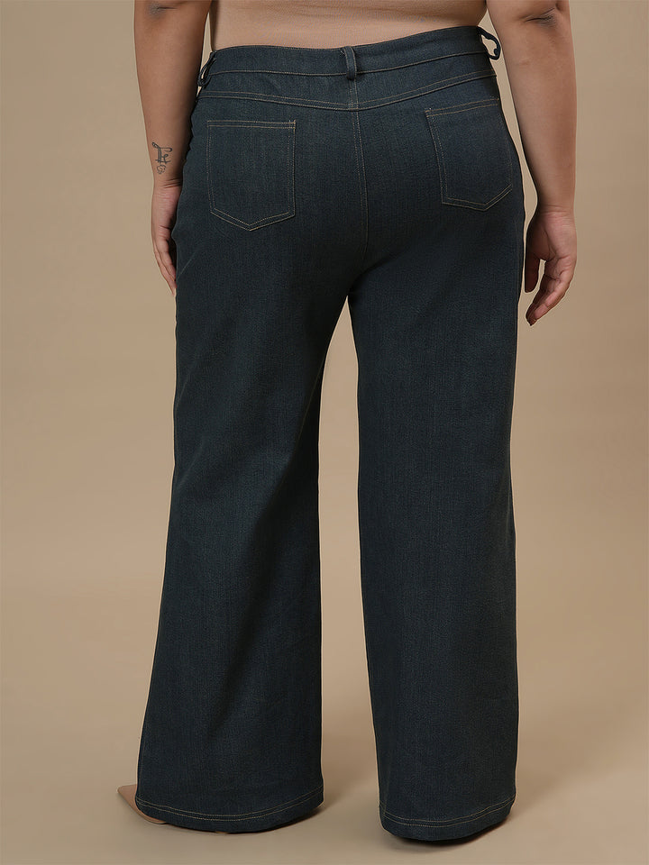 Plus-size woman in back view wearing Green Plus Size Bootcut Jeans with fitted hips and flared leg design