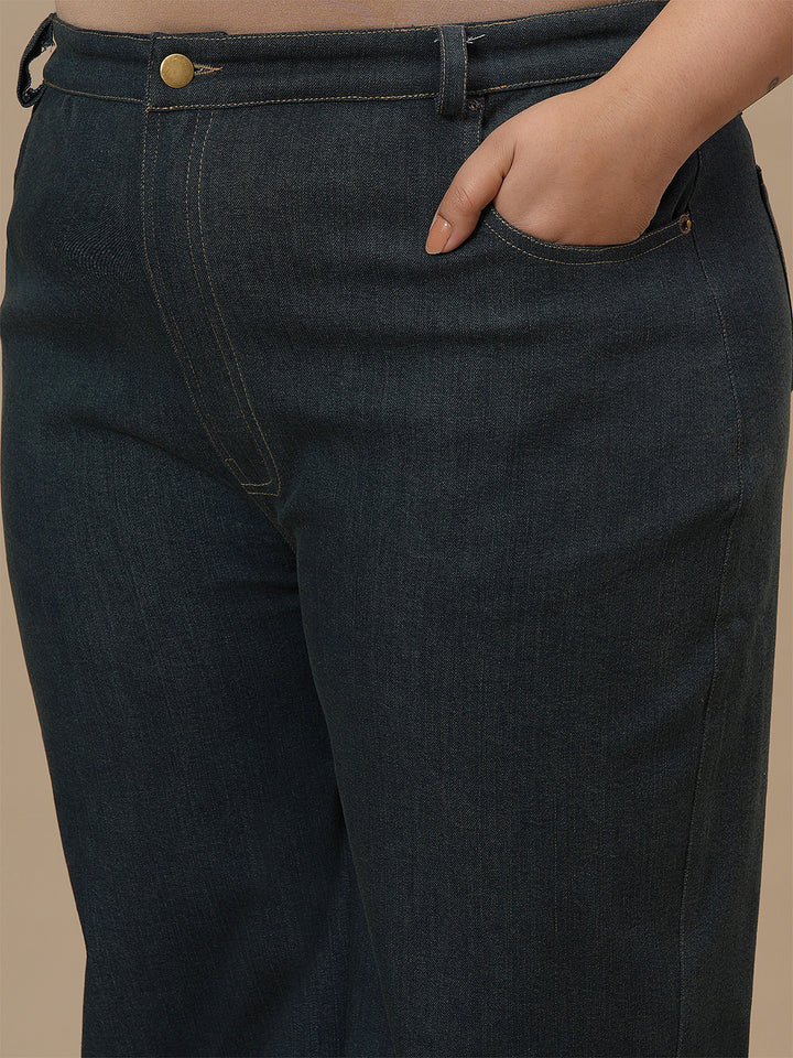 Close-up view of Green Plus Size Bootcut Jeans showing waistband and smooth denim texture