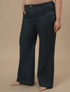 Plus-size woman in left side view wearing Green Plus Size Bootcut Jeans with high-rise waist and flared hem
