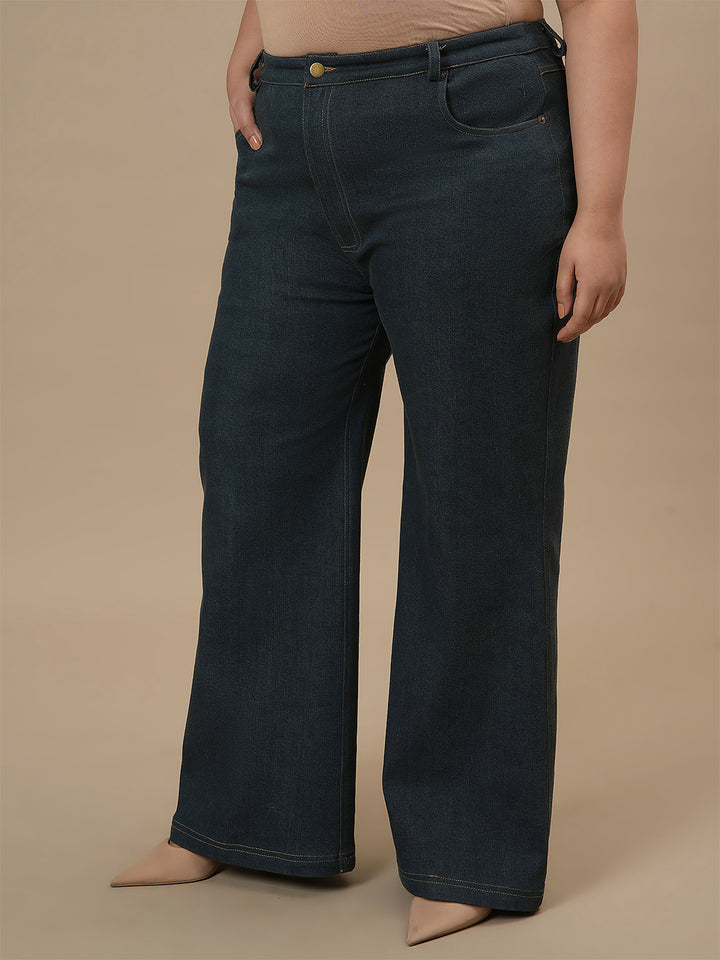Plus-size woman in left side view wearing Green Plus Size Bootcut Jeans with high-rise waist and flared hem