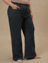 Plus-size woman in right side view wearing Green Plus Size Bootcut Jeans with high waist and subtle flare