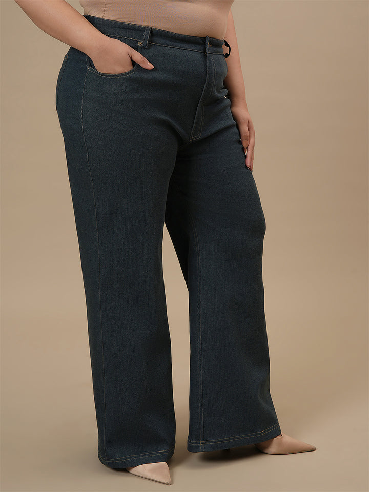 Plus-size woman in right side view wearing Green Plus Size Bootcut Jeans with high waist and subtle flare