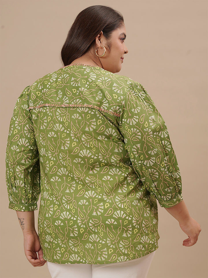 Plus-size woman in back view wearing Green Plus Size Floral Top with flowy silhouette and all-over floral print