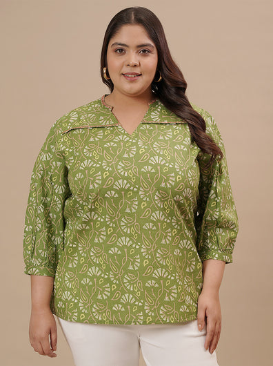 Plus-size woman in front view wearing Green Plus Size Floral Top featuring V-neckline and all-over floral print